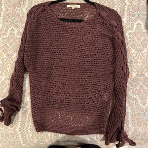 Brownish-red knit sweater with tie sleeves